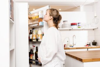 Pregnant woman searching fridge for food Pregnant woman searching fridge for food